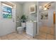 Bathroom featuring a toilet, sink with cabinet, and a view to the additional bedroom at 73 Alano Rd, Debary, FL 32713