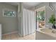 Small bathroom with window view and shower with curtain at 73 Alano Rd, Debary, FL 32713