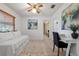 Bright bonus bedroom featuring a daybed, desk, and bright natural light at 73 Alano Rd, Debary, FL 32713