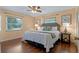 Cozy bedroom featuring a plush bed, hardwood floors, and soft lighting at 73 Alano Rd, Debary, FL 32713