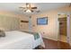 Comfortable bedroom with a mounted TV, hardwood floors, and an attached bathroom at 73 Alano Rd, Debary, FL 32713