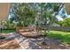 Wooden deck with built-in benches surrounded by trees and garden space at 73 Alano Rd, Debary, FL 32713