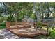 Close up of the wooden deck with built-in benches and backyard shed, perfect for outdoor enjoyment at 73 Alano Rd, Debary, FL 32713
