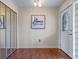 Foyer featuring decorative front door, mirror closet doors, and a 'Home' sign for a welcoming feel at 73 Alano Rd, Debary, FL 32713