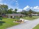Well-manicured single-story home on a corner lot, complete with mature trees and landscaping at 73 Alano Rd, Debary, FL 32713