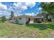 Well-maintained home exterior showing the lawn, landscaping and the enclosed porch at 73 Alano Rd, Debary, FL 32713