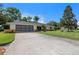 Lovely single Gathering house with a well-manicured lawn, paved driveway, and a two-car garage at 73 Alano Rd, Debary, FL 32713