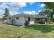Exterior view of the house with green grass and partial landscaping at 73 Alano Rd, Debary, FL 32713