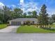 Inviting single-Gathering home featuring a spacious driveway and a beautifully maintained front yard at 73 Alano Rd, Debary, FL 32713