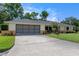 Charming single-story home with a well-manicured lawn and a spacious two-car garage at 73 Alano Rd, Debary, FL 32713