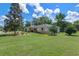Charming single-story home with a well-manicured lawn and mature landscaping at 73 Alano Rd, Debary, FL 32713