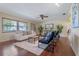 Comfortable living room with a soft white rug, stylish seating, and natural light at 73 Alano Rd, Debary, FL 32713