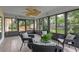 Enclosed sunroom with wicker chairs and a beautiful view of the backyard at 73 Alano Rd, Debary, FL 32713