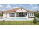 Expansive backyard showcasing a sparkling pool, patio, and outdoor kitchen at 7388 John Hancock Dr, Winter Garden, FL 34787