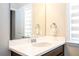 Bathroom with a white countertop vanity, mirror, and towel rack, providing a fresh space at 7388 John Hancock Dr, Winter Garden, FL 34787