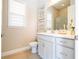 Bright bathroom featuring a white vanity, artwork, and a glass-enclosed shower at 7388 John Hancock Dr, Winter Garden, FL 34787
