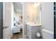 This bathroom features a white vanity with gray drawers and a view into the bright bedroom at 7388 John Hancock Dr, Winter Garden, FL 34787