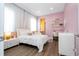 Charming bedroom with pastel accents, built-in shelving, and light wood flooring at 7388 John Hancock Dr, Winter Garden, FL 34787
