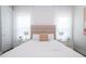Inviting bedroom with a queen bed, modern nightstands, decorative lamps, and soft, sheer curtains at 7388 John Hancock Dr, Winter Garden, FL 34787
