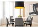 Cozy dining area featuring a white round table, modern gray chairs, and contemporary lighting at 7388 John Hancock Dr, Winter Garden, FL 34787