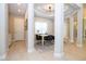 Dining area with stylish table, seating, and pillars, leading to other areas of the home at 7388 John Hancock Dr, Winter Garden, FL 34787