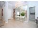Elegant foyer with a mirrored wall, stylish lighting, and a view towards the staircase and dining area at 7388 John Hancock Dr, Winter Garden, FL 34787