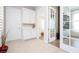 Entry hall with light tile floors, white doors and French doors leading into the office, and glimpses of the bedroom at 7388 John Hancock Dr, Winter Garden, FL 34787