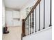 Bright hallway featuring stairs with decorative rails, tiled floors, and stylish storage cabinets at 7388 John Hancock Dr, Winter Garden, FL 34787