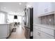 Kitchen with stainless steel appliances, white cabinetry, and view of dining area at 7388 John Hancock Dr, Winter Garden, FL 34787