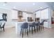 Spacious kitchen with stainless steel appliances, white cabinets and a large center island with barstool seating at 7388 John Hancock Dr, Winter Garden, FL 34787