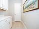 Laundry room with white cabinets, countertop, and a decorative painting at 7388 John Hancock Dr, Winter Garden, FL 34787