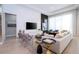 Bright and airy living room featuring modern decor, a large TV, and ample natural light at 7388 John Hancock Dr, Winter Garden, FL 34787
