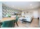 Bright living room with modern wallpaper, comfortable seating, and a round table at 7388 John Hancock Dr, Winter Garden, FL 34787