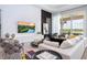 A modern living room features a large TV, contemporary decor, ample seating, and a sliding glass door to the patio at 7388 John Hancock Dr, Winter Garden, FL 34787