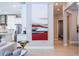 Modern living area featuring contemporary artwork and a partial view of the kitchen at 7388 John Hancock Dr, Winter Garden, FL 34787
