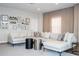 Cozy living room featuring a neutral sectional sofa, designer pillows, modern decor, and soft lighting at 7388 John Hancock Dr, Winter Garden, FL 34787