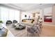 Open-concept living area with modern furniture and an adjacent kitchen and dining space at 7388 John Hancock Dr, Winter Garden, FL 34787