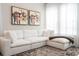 Comfortable living room featuring a large, sectional sofa, plush carpet, and bright, natural light from the windows at 7388 John Hancock Dr, Winter Garden, FL 34787