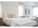 Spacious primary bedroom with a panel wall, plush bedding, and adjacent sitting area at 7388 John Hancock Dr, Winter Garden, FL 34787