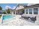 Backyard oasis with a sparkling pool, lounge area, and plush outdoor seating at 7388 John Hancock Dr, Winter Garden, FL 34787