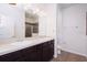 A full bathroom features a double sink vanity with dark wood cabinets, granite counters, and a tiled floor at 7557 Azalea Cove Cir, Orlando, FL 32807