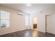 Bright and clean bedroom with wood-look floors, neutral paint, and an air conditioning unit, featuring two sunny windows at 7557 Azalea Cove Cir, Orlando, FL 32807