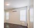 Bedroom featuring wood-look floors, two windows, and an air conditioning unit, with neutral paint and lots of light at 7557 Azalea Cove Cir, Orlando, FL 32807