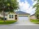 Charming single-story home with a well-manicured lawn and a two-car garage at 7557 Azalea Cove Cir, Orlando, FL 32807