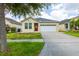 Charming single-story home with a well-manicured lawn and a two-car garage at 7557 Azalea Cove Cir, Orlando, FL 32807