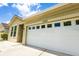 A close-up view of a two-car garage featuring windows and good lighting at 7557 Azalea Cove Cir, Orlando, FL 32807