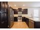 Kitchen featuring dark brown cabinets, stainless steel appliances and light countertops at 7557 Azalea Cove Cir, Orlando, FL 32807