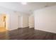 Large main bedroom with wood-look floors, neutral paint, multiple doors, and access to the main bathroom at 7557 Azalea Cove Cir, Orlando, FL 32807