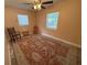 Inviting bedroom with a ceiling fan, carpet, and two bright windows at 7709 Ravenna Ave, Orlando, FL 32819