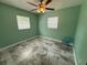 Bright bedroom with a ceiling fan, light green walls, and marble floors at 7709 Ravenna Ave, Orlando, FL 32819